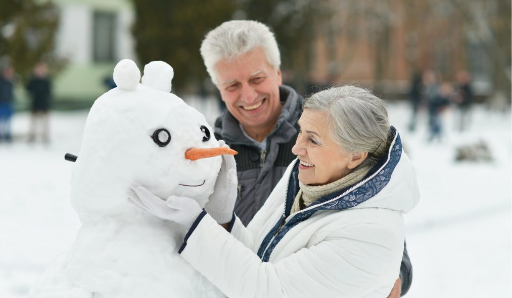 winter senior couple snowman