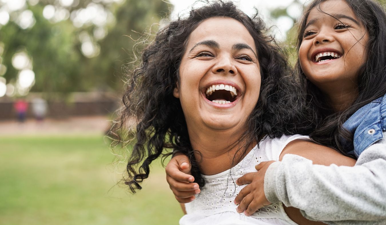 latina mother and daughter laughing