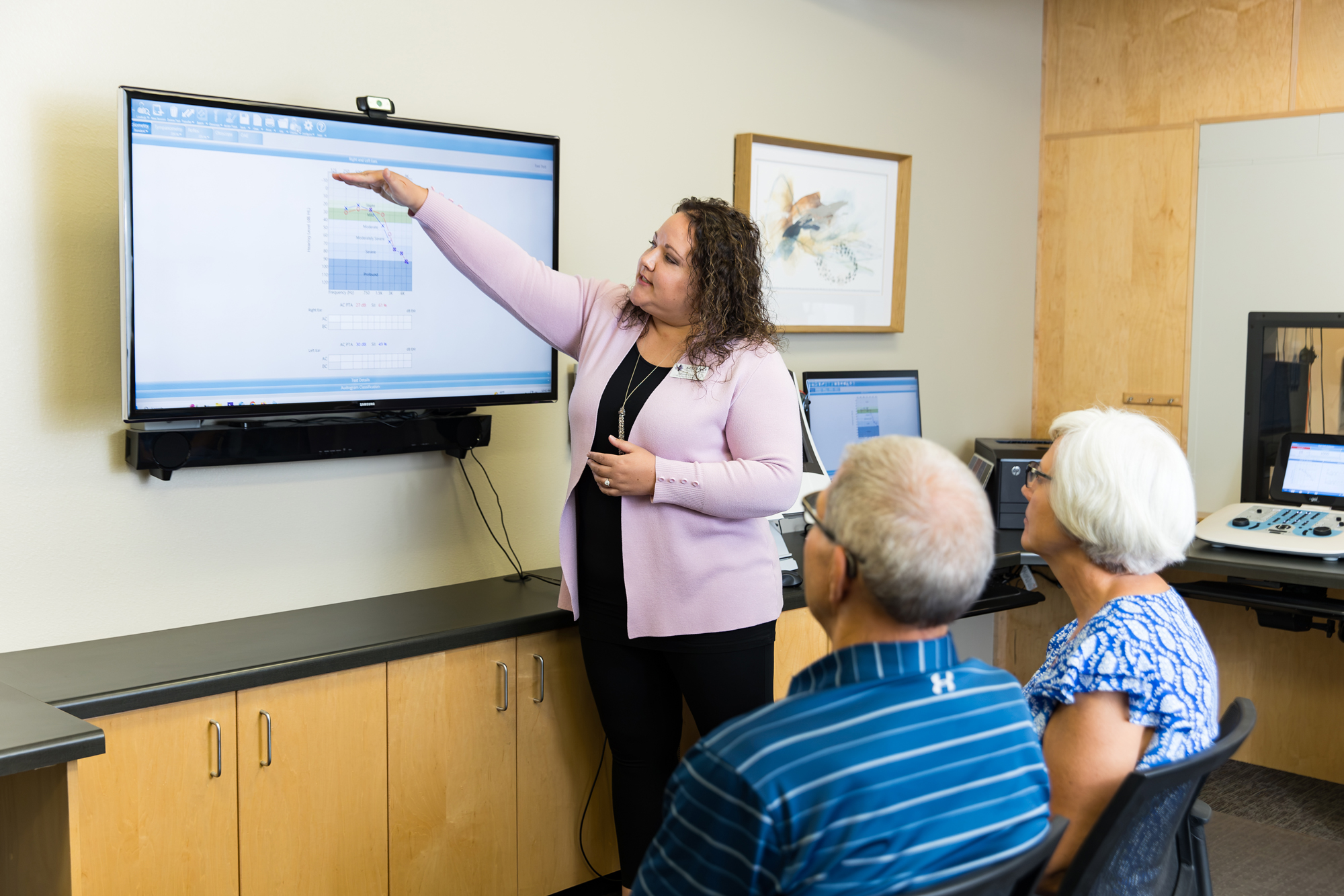 amanda going over hearing evaluating results with senior couple during consultation