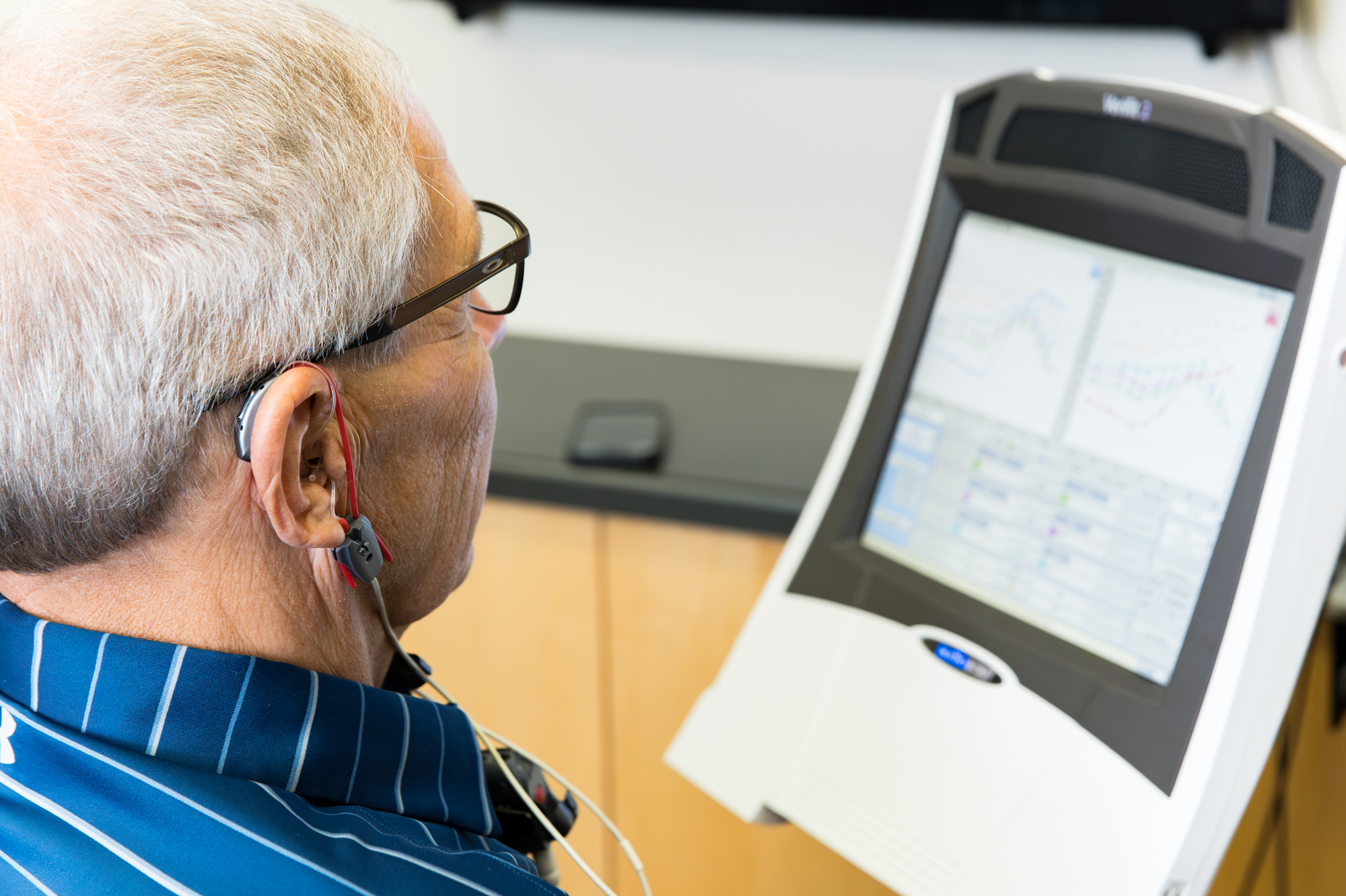 senior man taking a diagnostic hearing evaluation