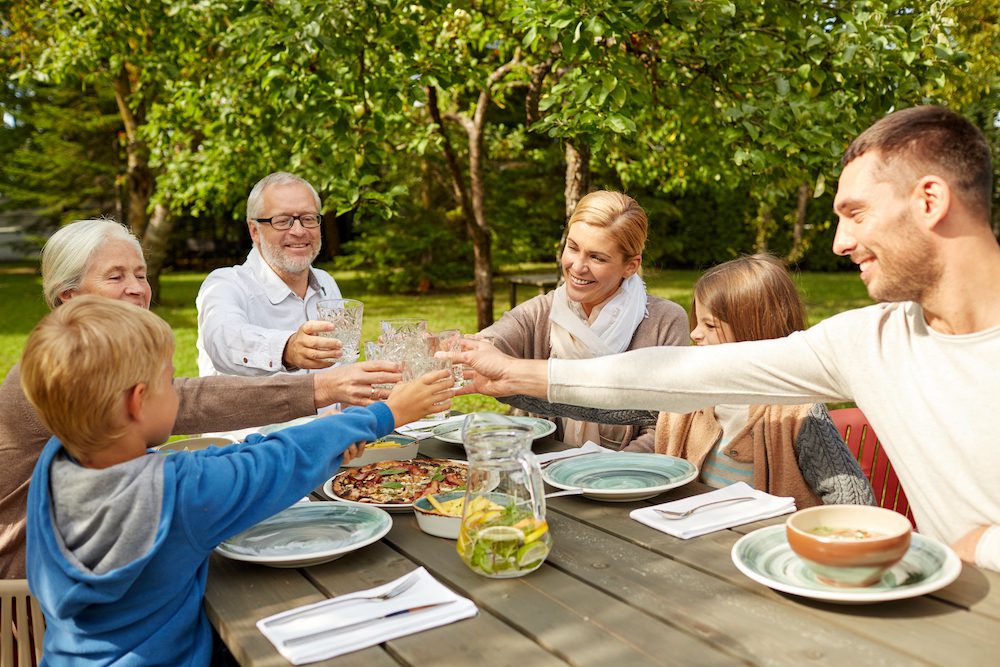 family eating lunch at picnic table