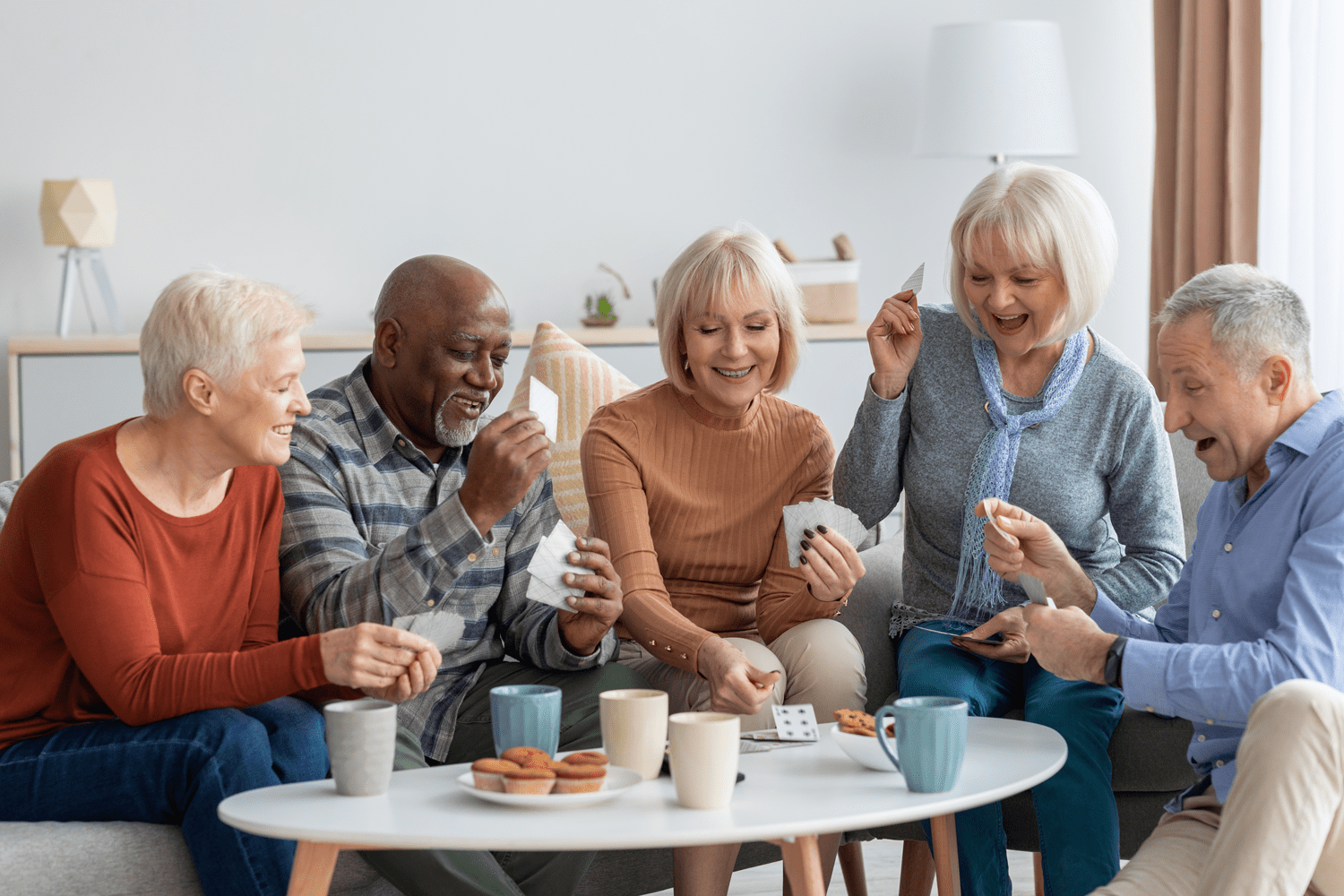 senior friends playing cards
