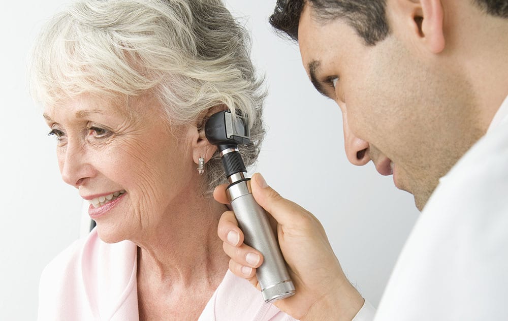 an ear doctor examining his patient