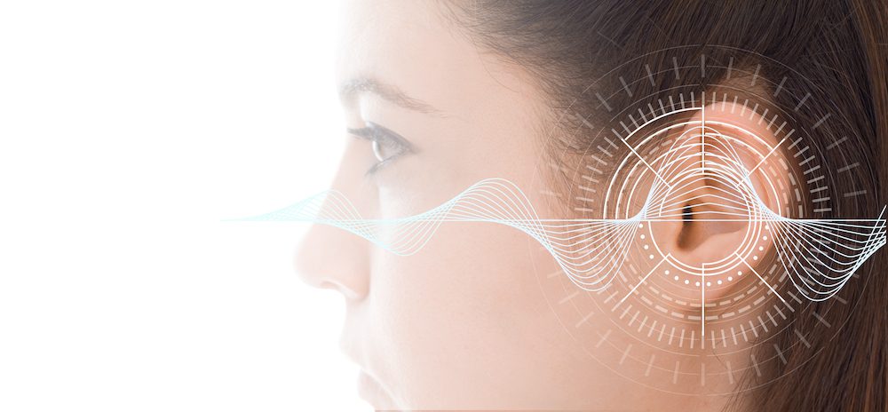 diagram of ear superimposed on womans head and ear