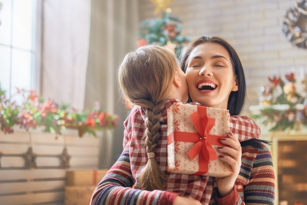woman giving gift to her child