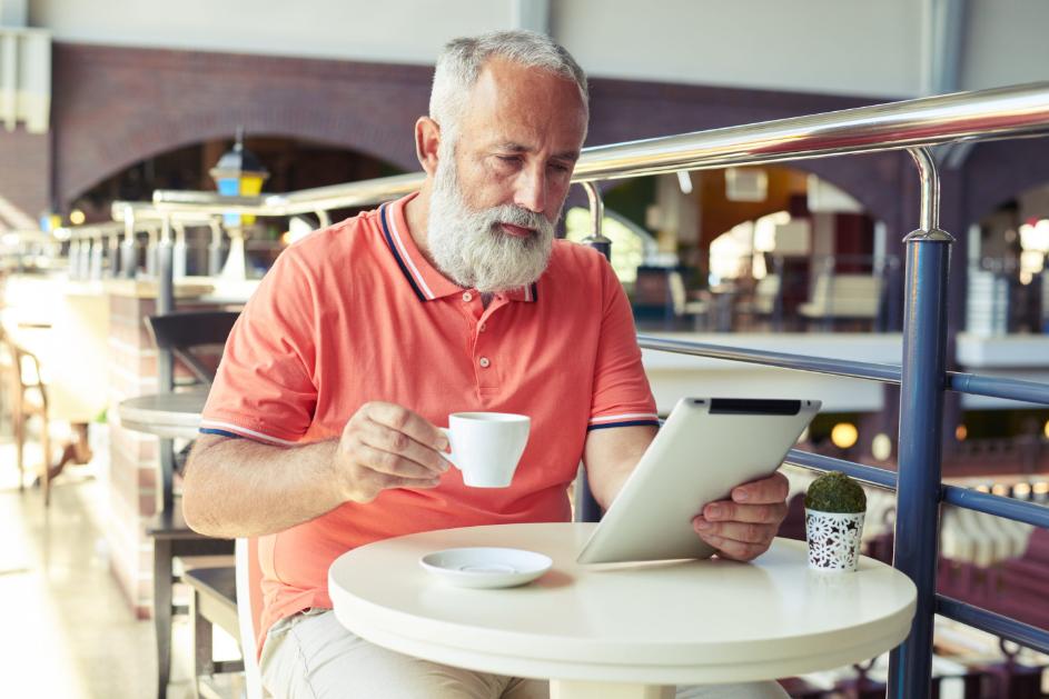 man reading at a coffee shop