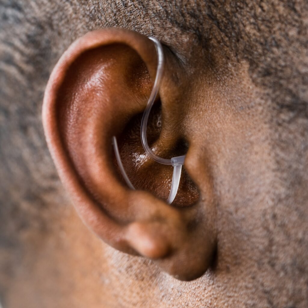 senior black male hearing aid closeup