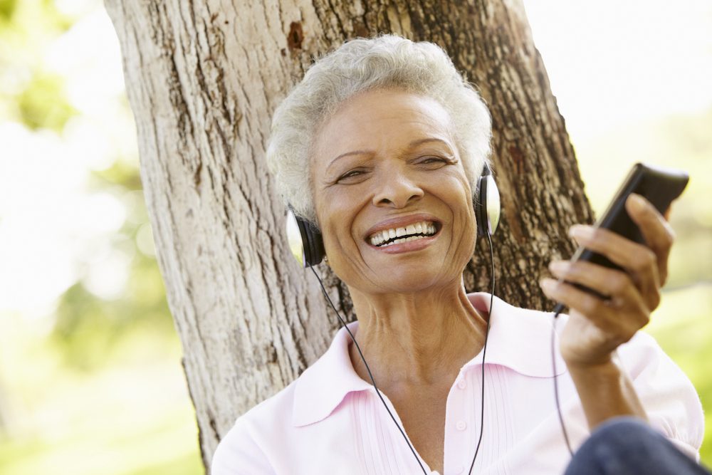 woman listening to music outside on a beautiful day