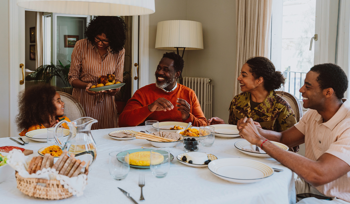 food family supper gathering everyone smiling looking at granddaughter