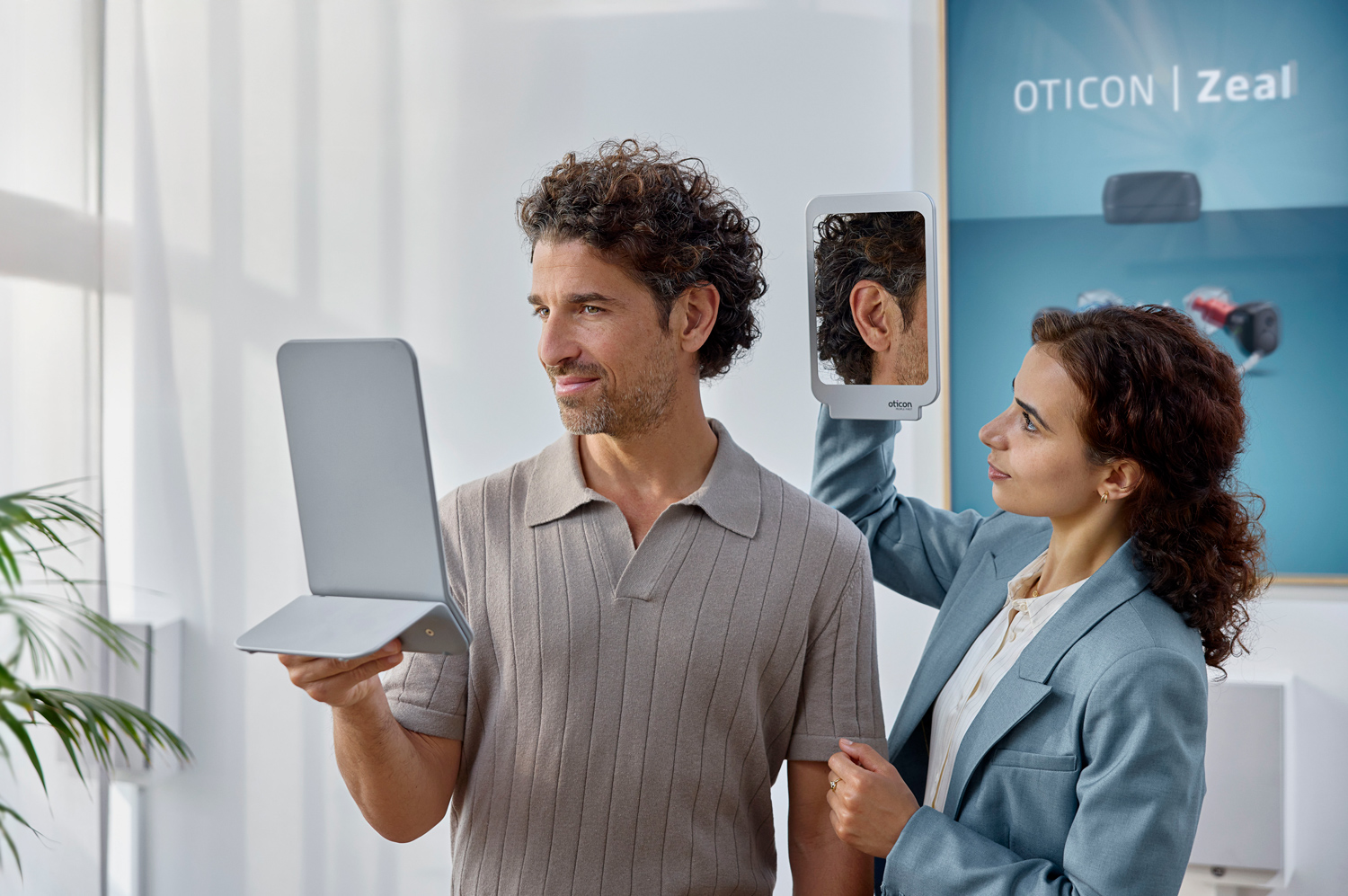 oticon zeal lifestyle man trying hearing aid with professional