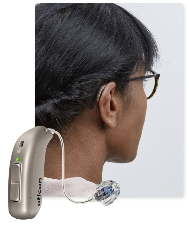 RIC hearing aid in front of woman in glasses wearing the same hearing aid.