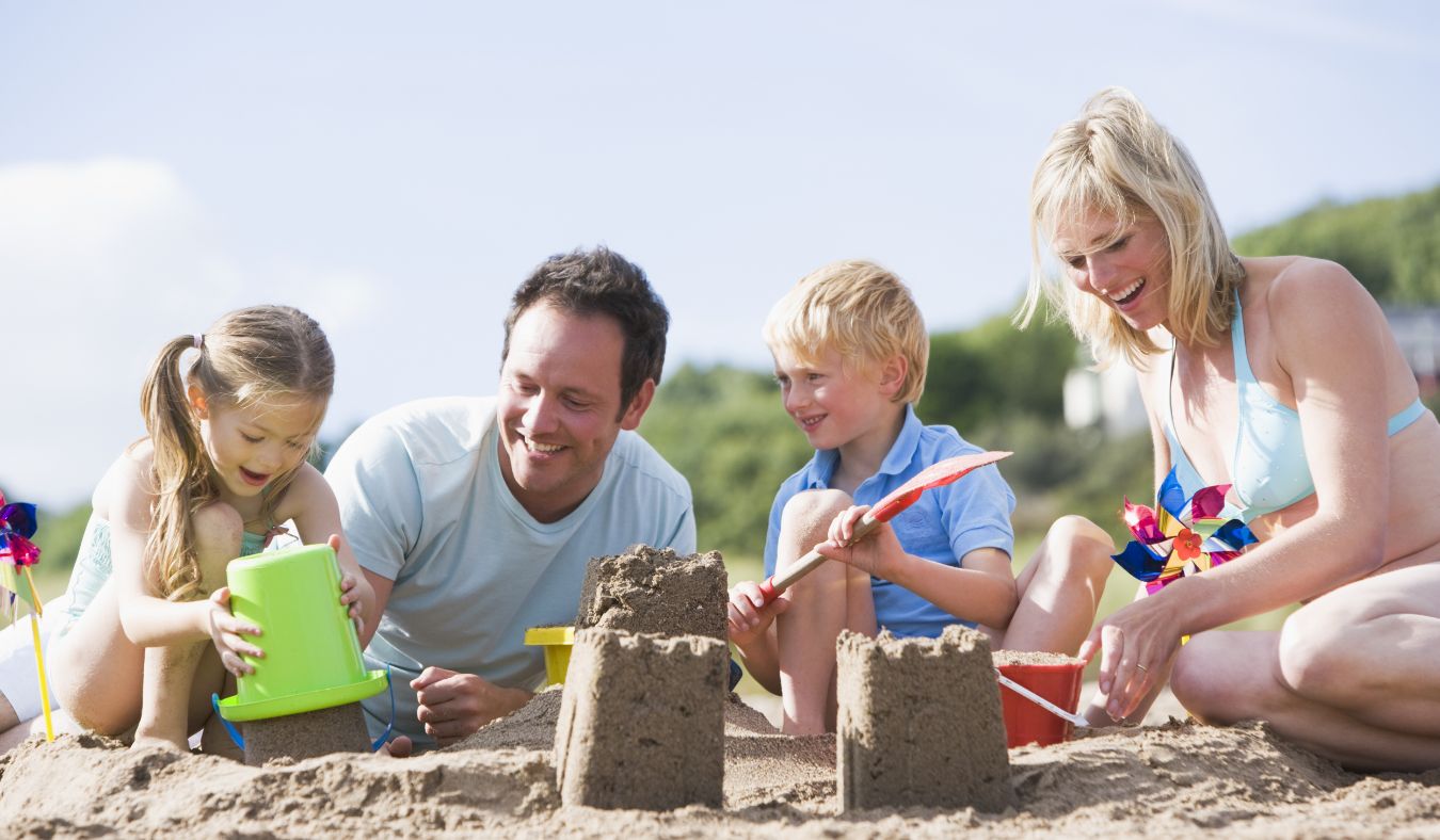 beach family building sandcastle