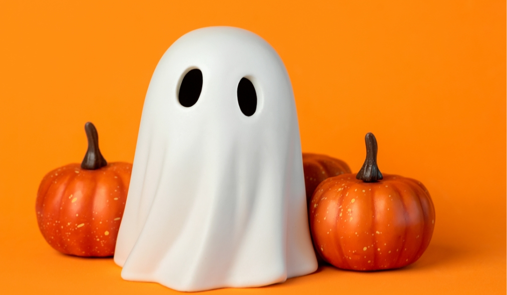 events halloween ghost next to pumpkins