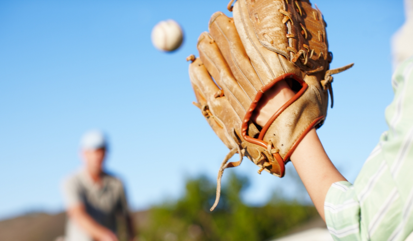 son and father playing catch with baseball