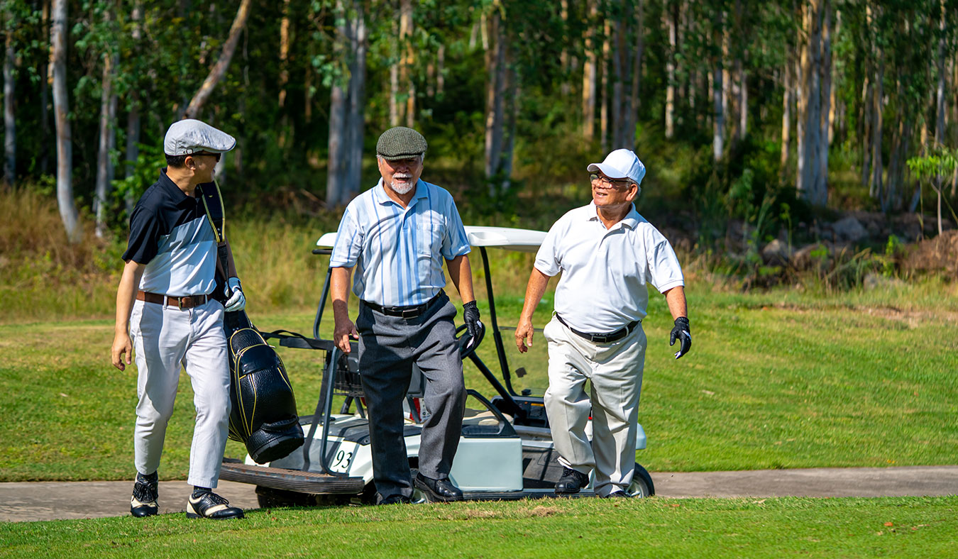 events senior asian men walking along golf course
