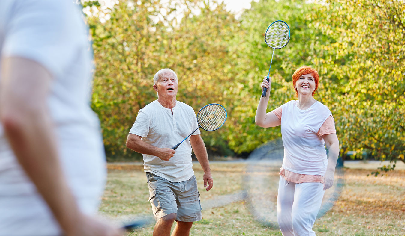 events senior couple playing badminton outside