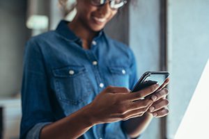 smiling woman using app on her iphone
