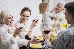 family eating and drinking at restaurant