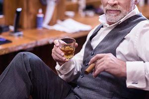 suave man drinking glass of scotch