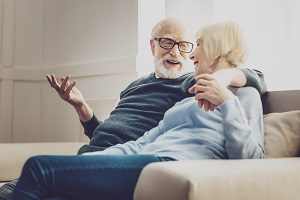 man talking with his wife on comfy couch