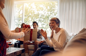 grandmother receiving holiday gift from family members