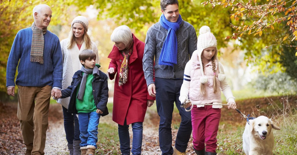 children and parents walking dog on chilly day