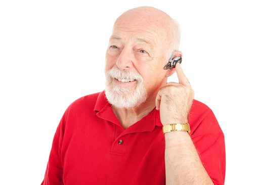 happy senior male using black hearing aids