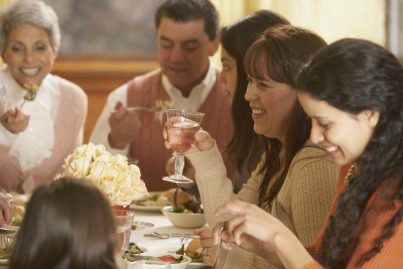 group of adults enjoying themselves at dinner