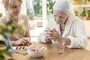 woman with senior mother at table