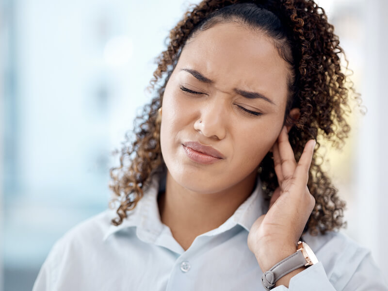 woman in slight pain ear