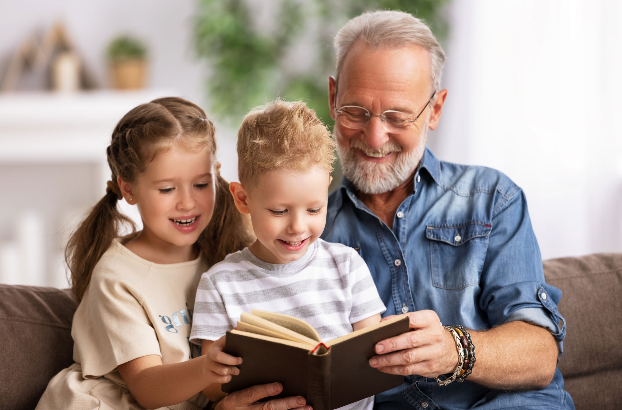 grandfather reading grandchildren