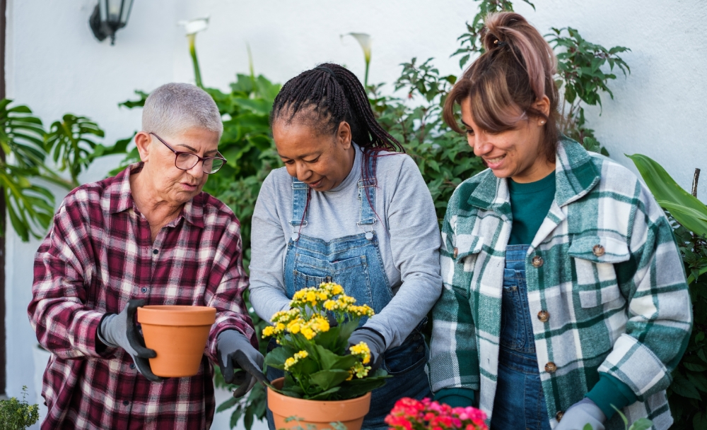 group of diverse friends planting flowers