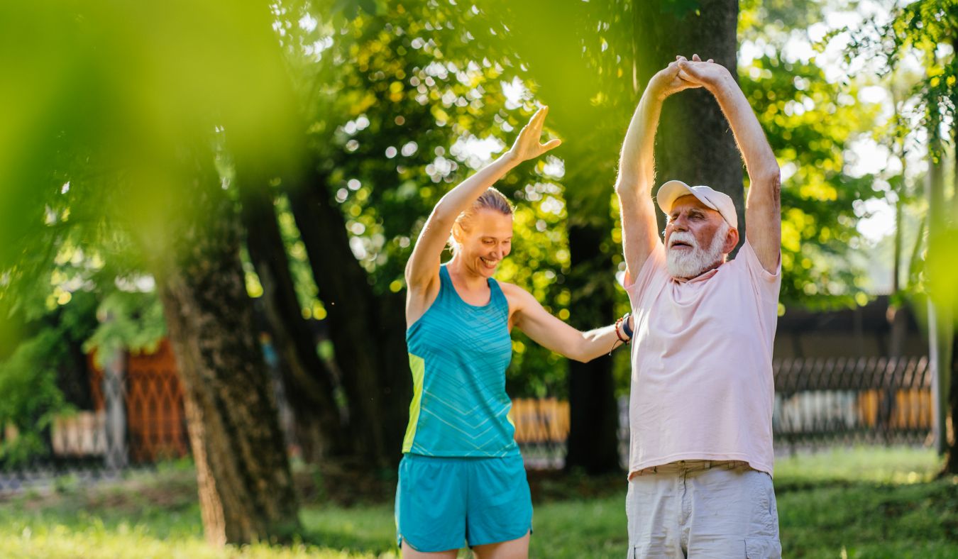 exercise mature man and woman stretching