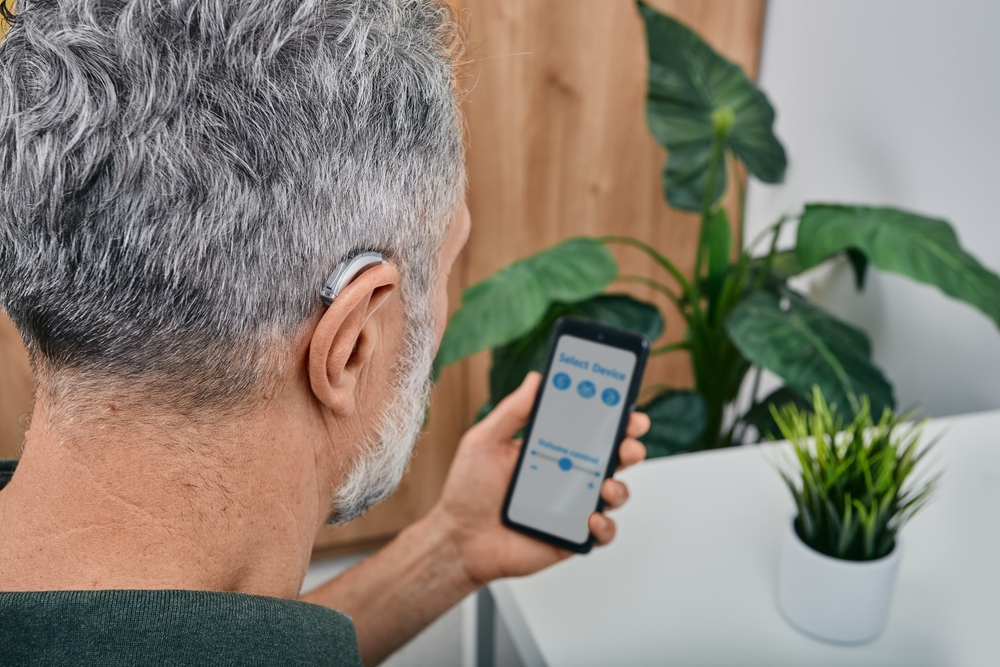Hearing,Impaired,Mature,Man,Adjusts,Settings,For,His,Bte,Hearing