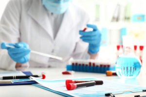 Test tubes with blood samples on table in laboratory Test tubes with blood samples on table in laboratory