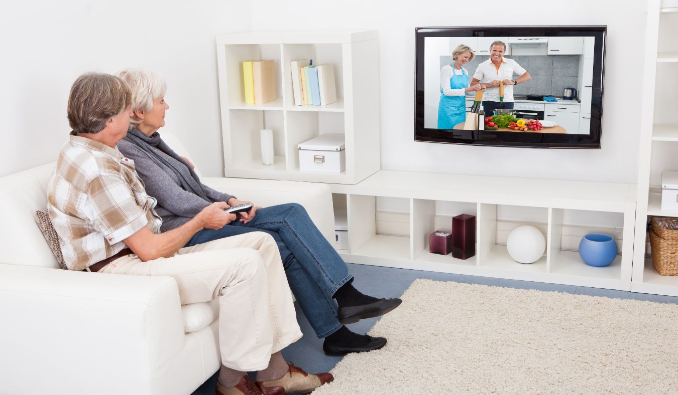 senior couple watching tv