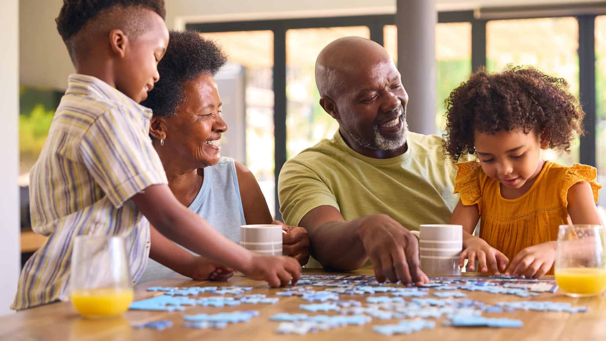 grandparents grandkids putting together puzzle piece