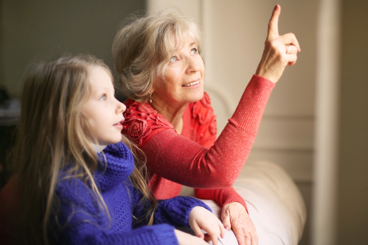 grandmother looking out window granddaughter