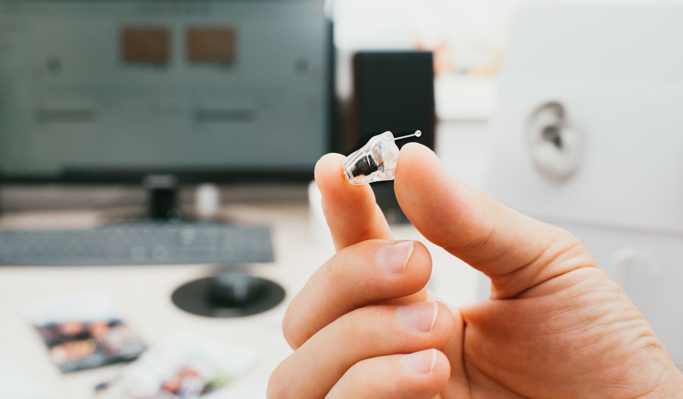 hearing aid in hand in the ear model