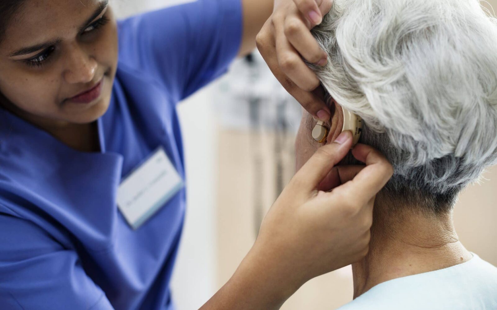 woman hearing aid adjustment