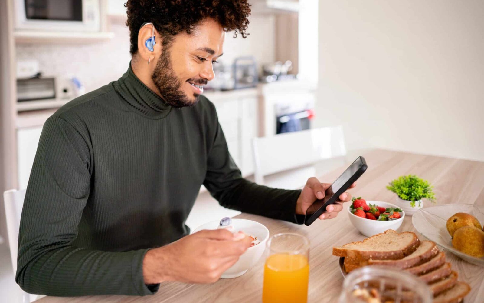 young man hearing aids phone rechargeable