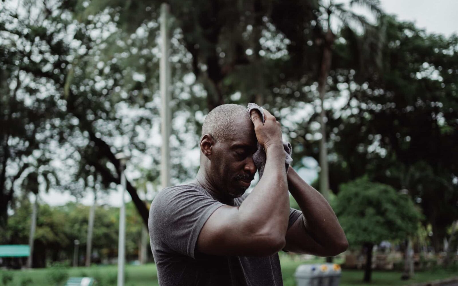 man sweating outdoors heat humidity hearing aids