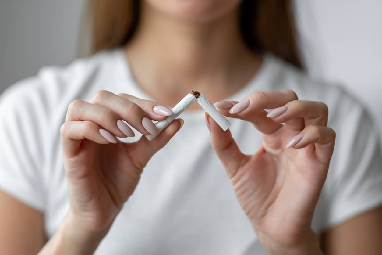 Woman breaks cigarette