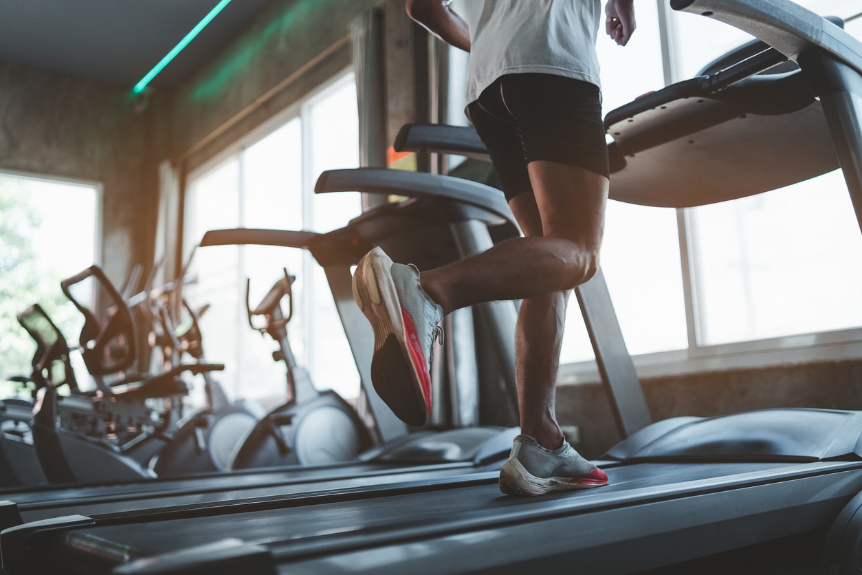 Close up of feet, runner on treadmill in fitness club Cardio workout Healthy lifestyle, guy training in gym Sport running concept