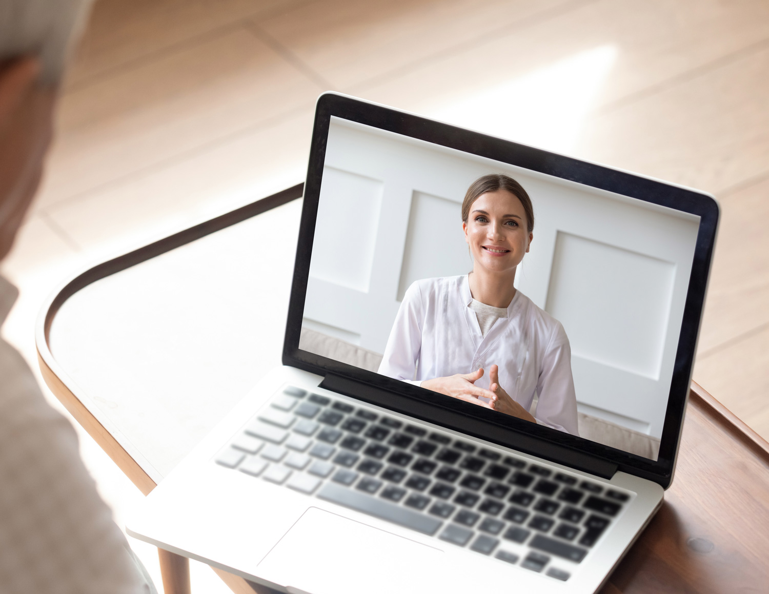telehealth woman doctor meeting with senior