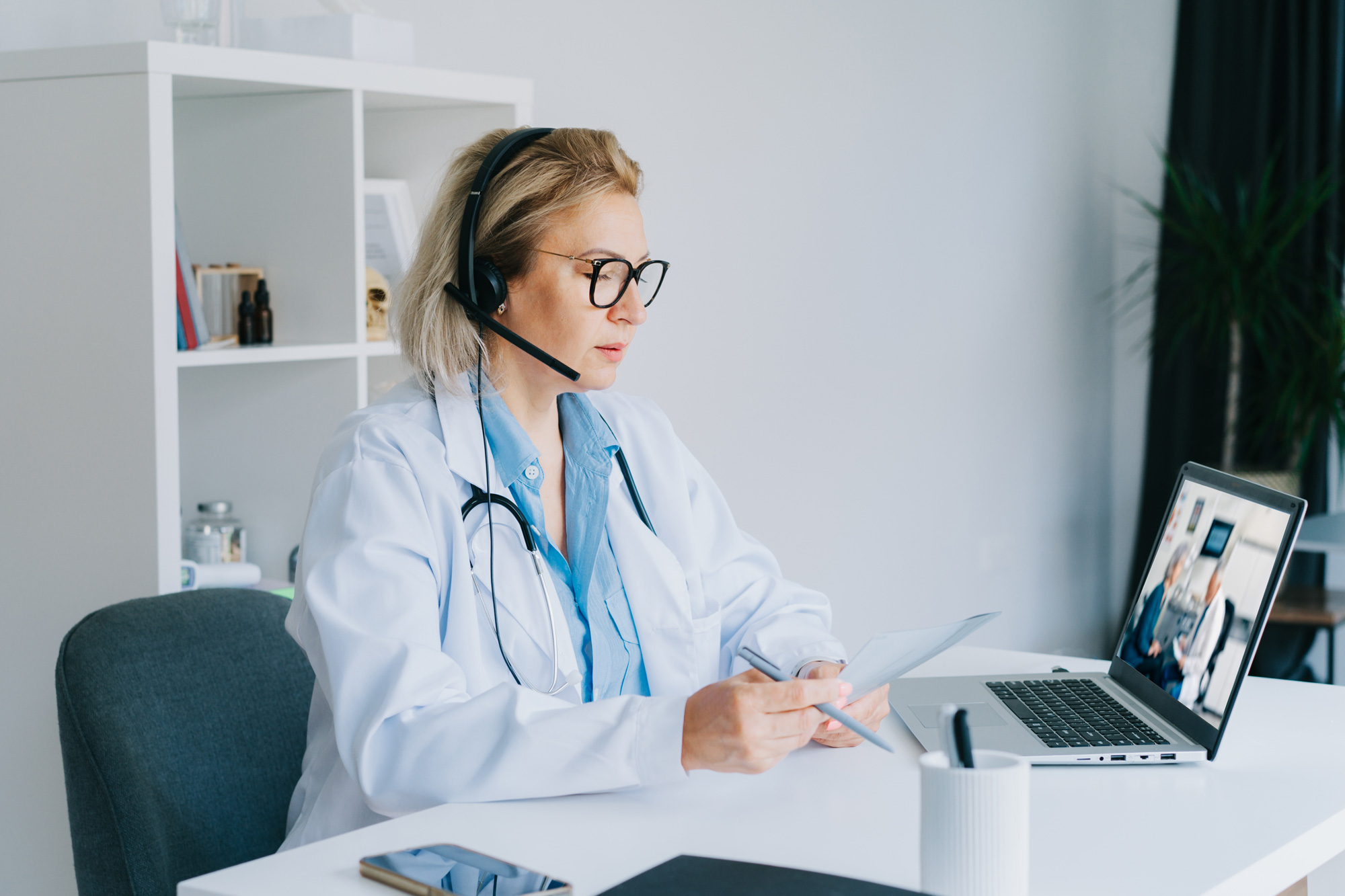 audiologist providing care over telehealth appointment with ent office