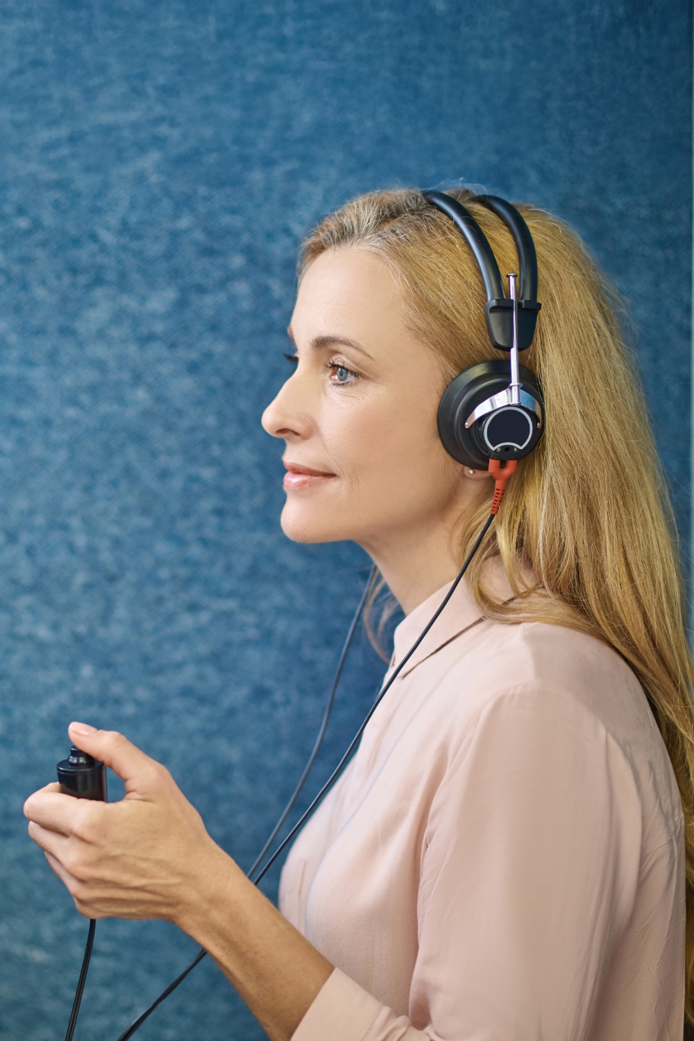 patient taking a hearing evaluation sound booth