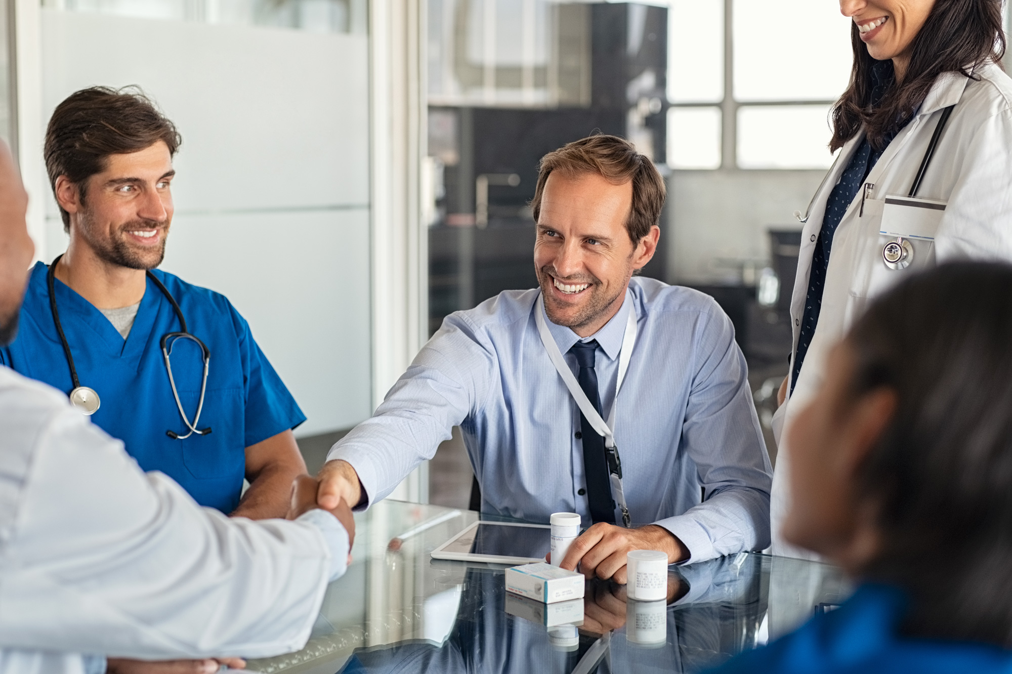 medical professionals shaking hands forming a partnership
