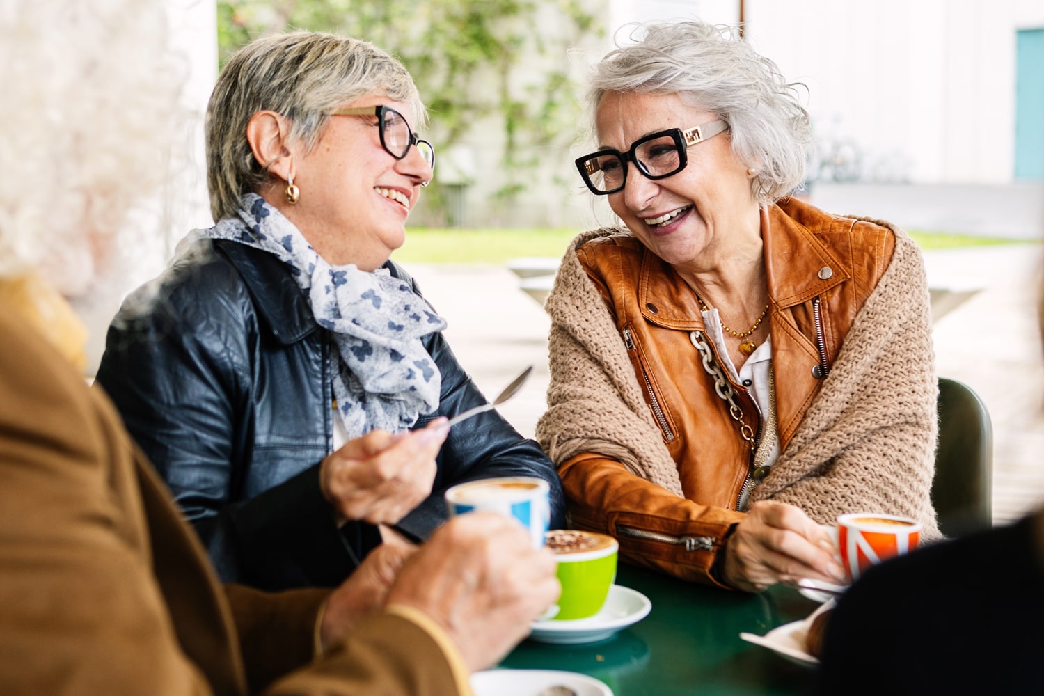 older women friends laughing during tea time