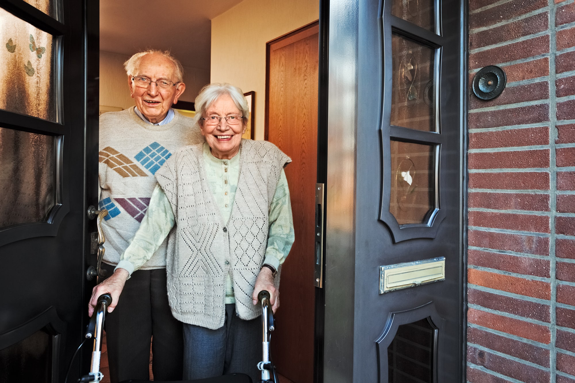 senior couple opening door